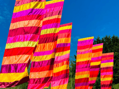 Gestreepte festivalvlaggen tegen een blauwe lucht